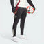 The Black Tiro 24 pants, highlighting the slim-cut legs and the signature white Adidas 3-Stripes.