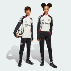 Side profile of the Kids' Man Utd Tiro 24 pants, highlighting the slim, tapered leg and the classic white 3-Stripes branding.