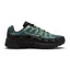 Highlights the early-2000s lateral silhouette featuring the Mineral Slate green mesh upper, layered black textured leather and Steam green cage overlays, moulded black Nike Swoosh with embroidered Steam trim, sculpted black foam midsole, and black rubber outsole.