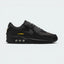 Highlights the high-velocity sweep of the crisp White Nike Swoosh, showing the professional, layered texture of the Black and Anthracite panels resting above the bold University Gold Max Air cassette window frame.