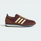 Highlights the high-velocity "Almost Yellow" 3-Stripes and the professional depth of the Maroon suede.