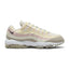 Displays the full lateral silhouette featuring the signature wavy layered synthetic upper in Spruce Fog, Alabaster, and Silt Red, an Anthracite Nike Swoosh near the heel, visible Max Air units in the midsole, and the turf-ready rubber lug outsole.