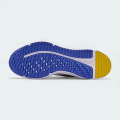 View of the outsole of the Nike Cosmic Runner Juniors' white running trainers, showing the durable rubber tread pattern for multi-surface traction.