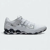 Nike Reax 8 Training Shoes Men's in white with metallic silver accents, side profile showing mesh upper, distinctive Reax cushioning pillars in the heel, and Nike Swoosh.