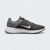 Nike Revolution 6 Next Nature Men's running trainers in iron grey with a white midsole, side profile showing mesh upper, soft foam cushioning, and Nike Swoosh.