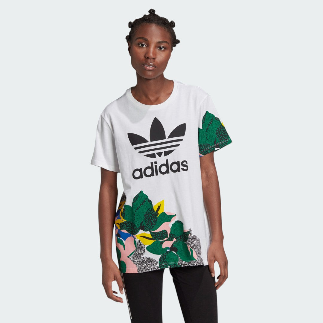 Woman wearing the Adidas x Her Studio London Loose Shirt with a multi-coloured Trefoil logo, demonstrating its casual, stylish fit.