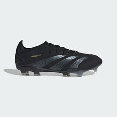 Adidas Predator Pro FG men's football boots in black with gold metallic accents, side profile showing the Strikeskin grip texture on the upper and the firm ground studs.