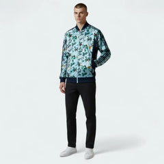 Man wearing a patterned jacket and black pants on a white background