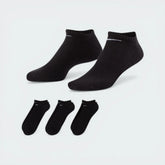 The Black lightweight no-show sock, highlighting the low-cut ankle line and the high-contrast white Nike Swoosh.