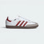 Highlights the high-velocity Preloved Ruby 3-Stripes and the professional, gleaming depth of the metallic gold foil Samba branding.