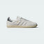 Highlights the high-velocity sweep of the Carbon grey serrated 3-Stripes, the professional gold-foil Samba text, and the striking visual depth of the Grey One butter soft leather upper.