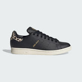Adidas Stan Smith Women's trainers in black leather, side profile showing the perforated 3-Stripes and a leopard print heel tab.