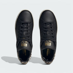 Top-down view of a pair of Adidas Stan Smith Women's trainers in black, highlighting the leather upper, black laces, and iconic design.