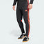 Side profile of the Black and Lucid Red Tiro 25 pants, highlighting the vibrant red 3-Stripes and the tapered leg silhouette.