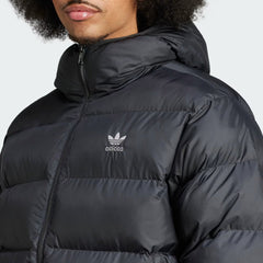 Close-up zoom on the fabric of the Adidas Tonal Hooded Puffer Jacket, showing the quilted puffer texture and subtle Adidas logo.