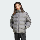 Adidas Tonal Hooded Puffer Jacket Men's in grey showing a model wearing the jacket along with suitable clothing