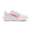 Highlights the lateral profile featuring a bold Bright Crimson Swoosh outlined in orange sweeping across the white mesh upper, Washed Coral midsole rim accent stamped with "ComfiRide", white foam midsole carrier, and a Washed Coral rubber outsole.