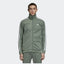 Person wearing a green Adidas tracksuit on a white background