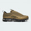 Highlights the high-velocity sweep of the liquid Metallic Gold layered wave panels, showing the professional integration of the miniature Varsity Red side Swoosh and the clear depth of the VaporMax bubbles below.