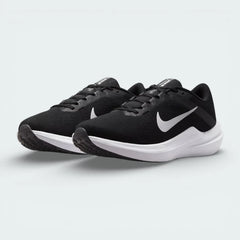 Angled view of two Nike Winflo 10 Women's trainers side by side, showcasing the modern athletic silhouette and contrasting black and white design.
