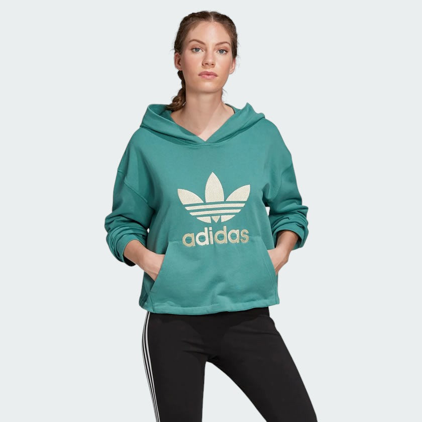 Adidas Premium Hoodie Trefoil Overhead Women's in noble green, front view showing adjustable hood, prominent metallic gold Trefoil logo, and a kangaroo pocket.