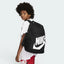 Highlights the high-velocity sweep of the comfortable padded shoulder straps, showing the professional, clean texture of the black woven canvas body and the expanding mesh water bottle pocket sitting flush on the flank.