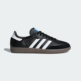 Adidas Samba OG Men's trainers in black leather with white 3-Stripes and a gum sole, side profile showing suede T-toe and classic silhouette.