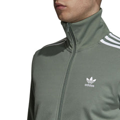 Close-up zoom on the Adidas Beckenbauer Track Jacket Men's, showing the soft doubleknit fabric texture and the detailed embroidered Trefoil logo.