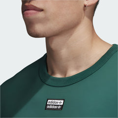 Close-up zoom on the Adidas R.Y.V. Long Sleeve Men's T-Shirt in green, showing the soft cotton jersey fabric texture and the detailed R.Y.V. logo print.