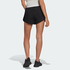 adidas Adicolor 3-Stripes Women's Shorts GN2885 worn seated or during movement showing comfort and flexibility from the rear