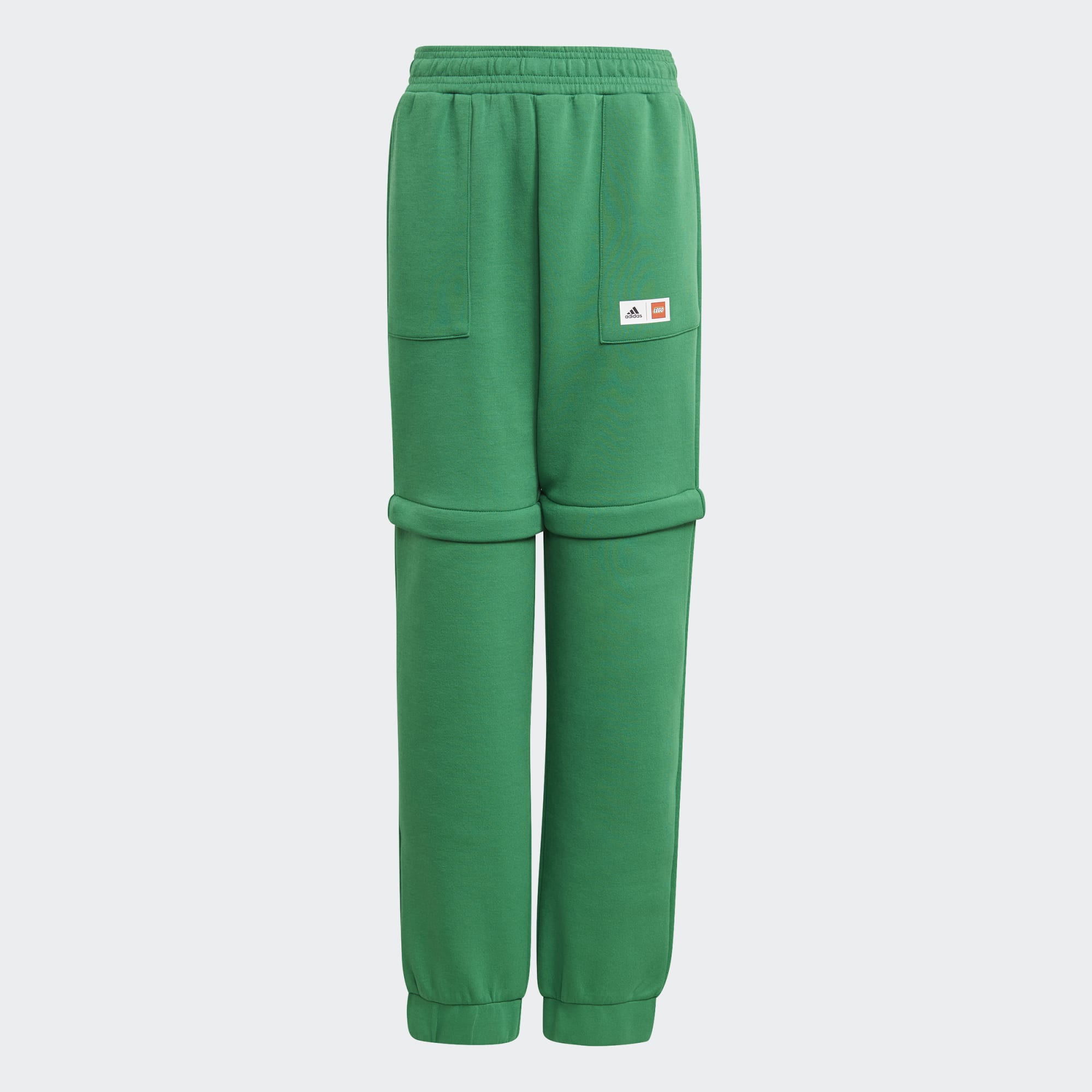adidas x LEGO Kids' Fleece Track Pants GN6803 front view showing green fleece and LEGO-inspired design