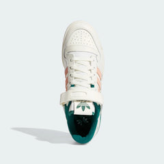 Top-down view of a pair of Adidas Forum 84 Low Men's trainers in off-white, highlighting the lace-up closure and adjustable ankle strap.