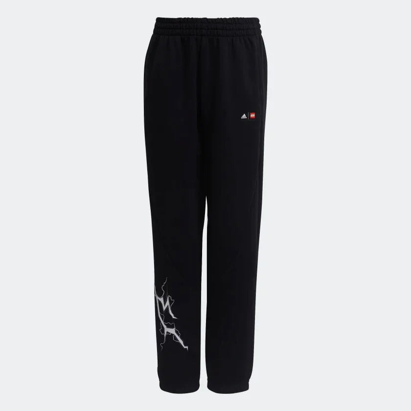 Black Adidas track pants with a white and red graphic on the left leg, featuring an elastic waistband with a drawstring and Adidas branding on the upper left.