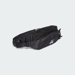 Side profile of the Adidas Adventure Waist Bag in black, highlighting its compact depth and compression straps (if visible).