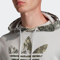 Close-up zoom on the fabric of the Adidas Originals Camouflage Hoodie, showing the soft fleece texture and the detailed Trefoil logo print.