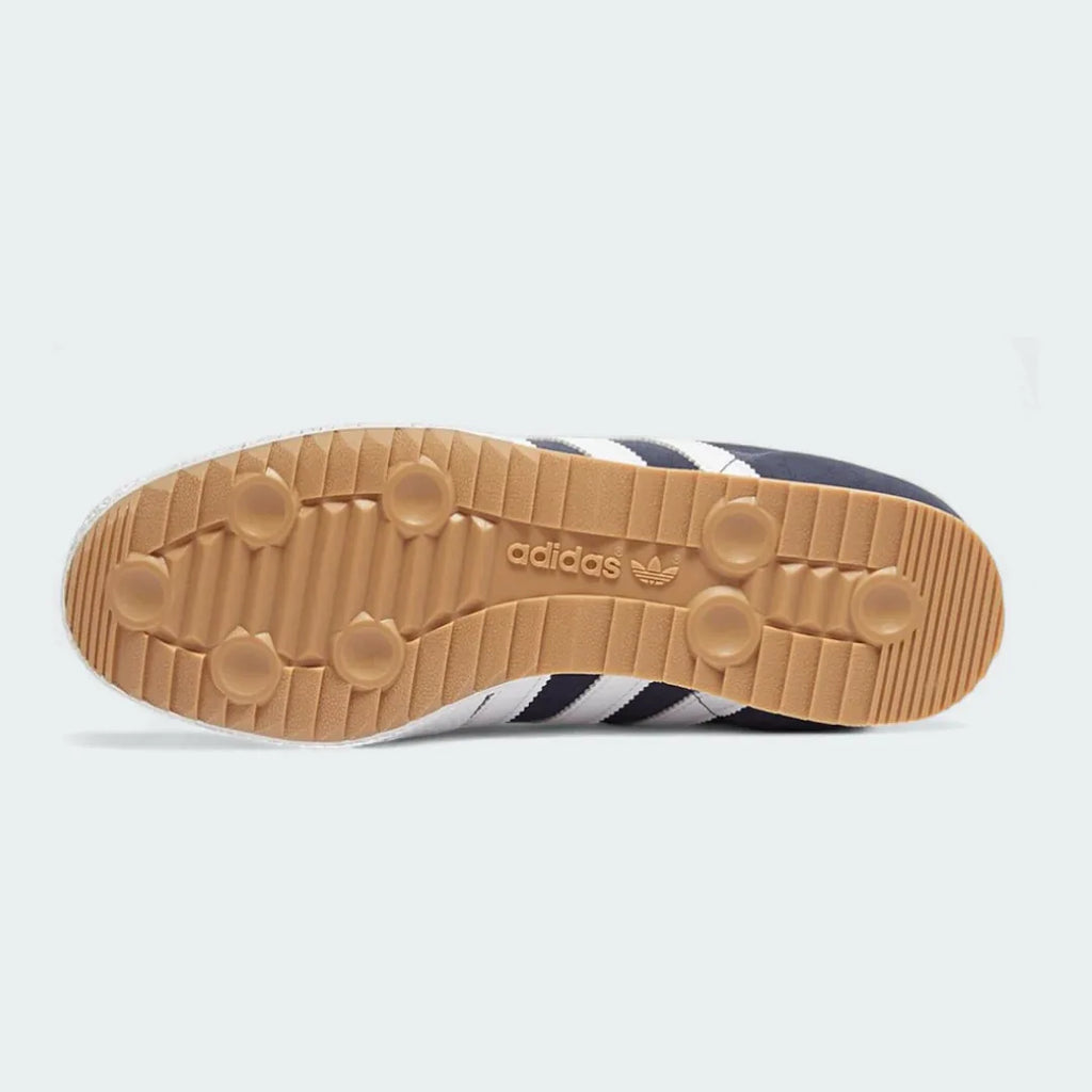 View of the outsole of the Adidas Samba Super Men's navy trainers, showing the textured gum rubber sole with its soccer-inspired pivot point and traction pattern.