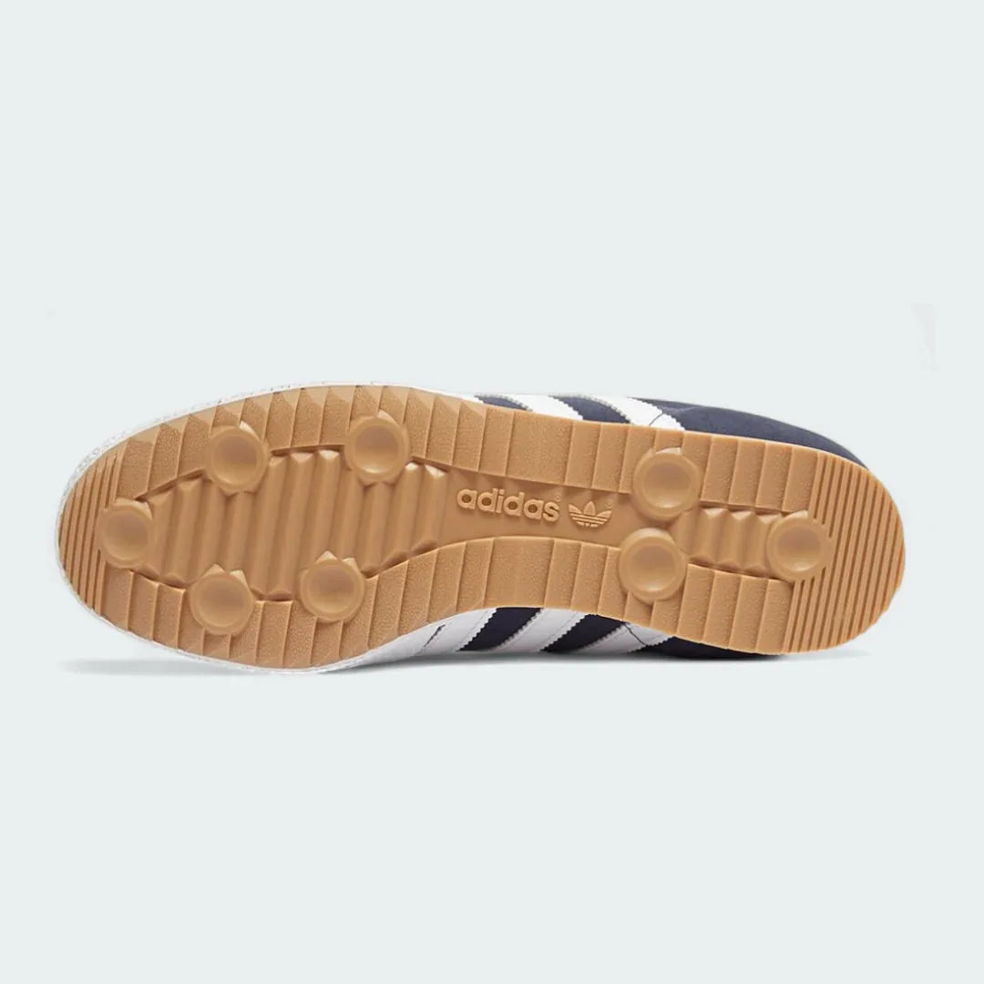 View of the outsole of the Adidas Samba Super Men's navy trainers, showing the textured gum rubber sole with its soccer-inspired pivot point and traction pattern.