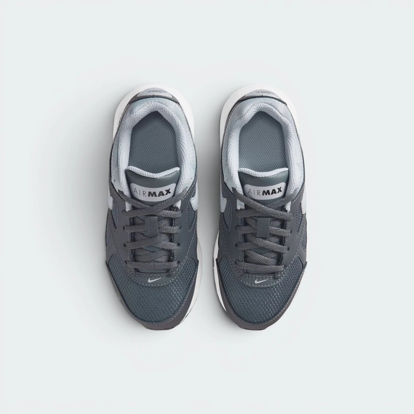Focuses on the locked-in lace closure layout, the technical dark grey mesh on the toe box, and the classic branded tongue patches.