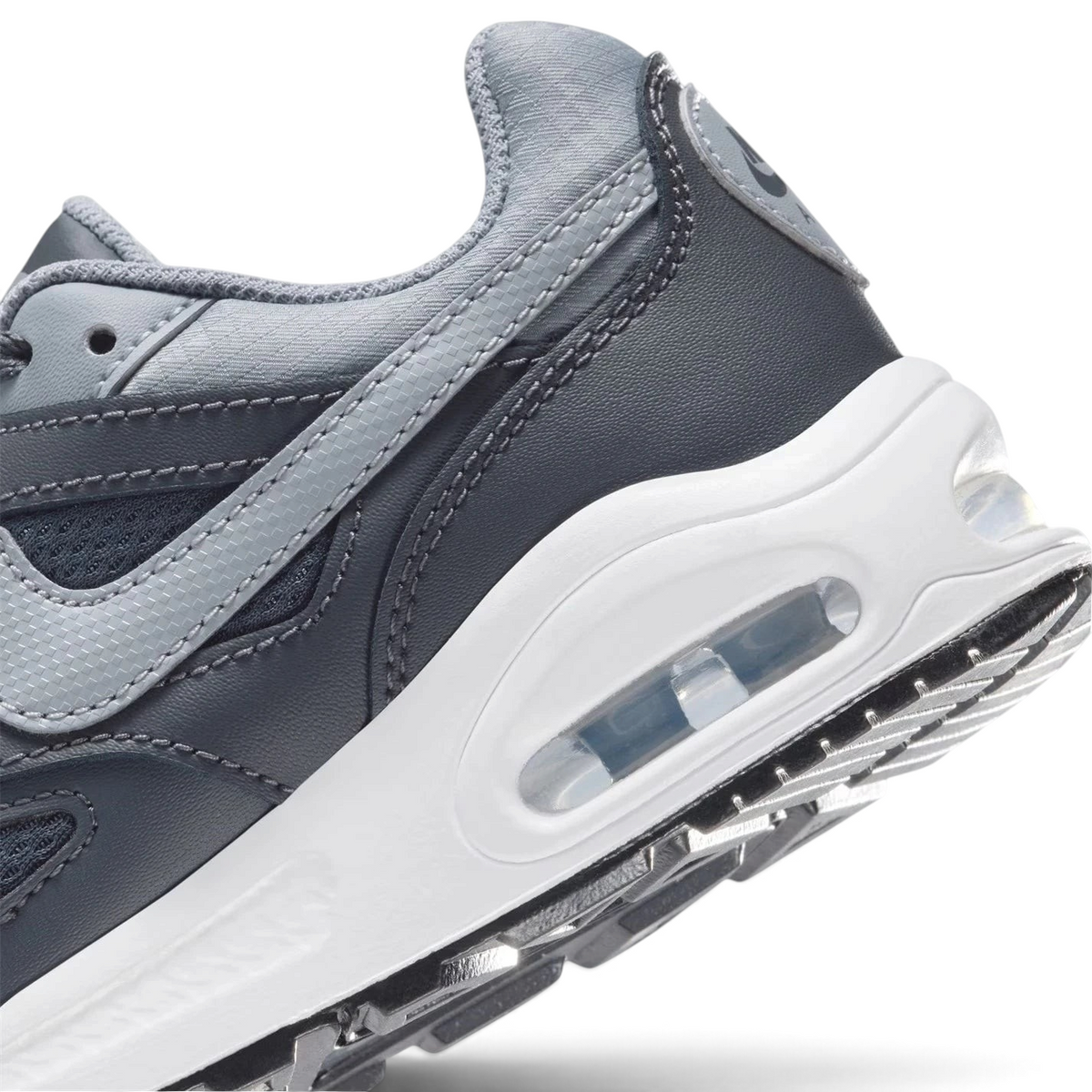 Highlights the "unreal" clean finish where the visible Max Air heel window cuts through the stable foam midsole wall.