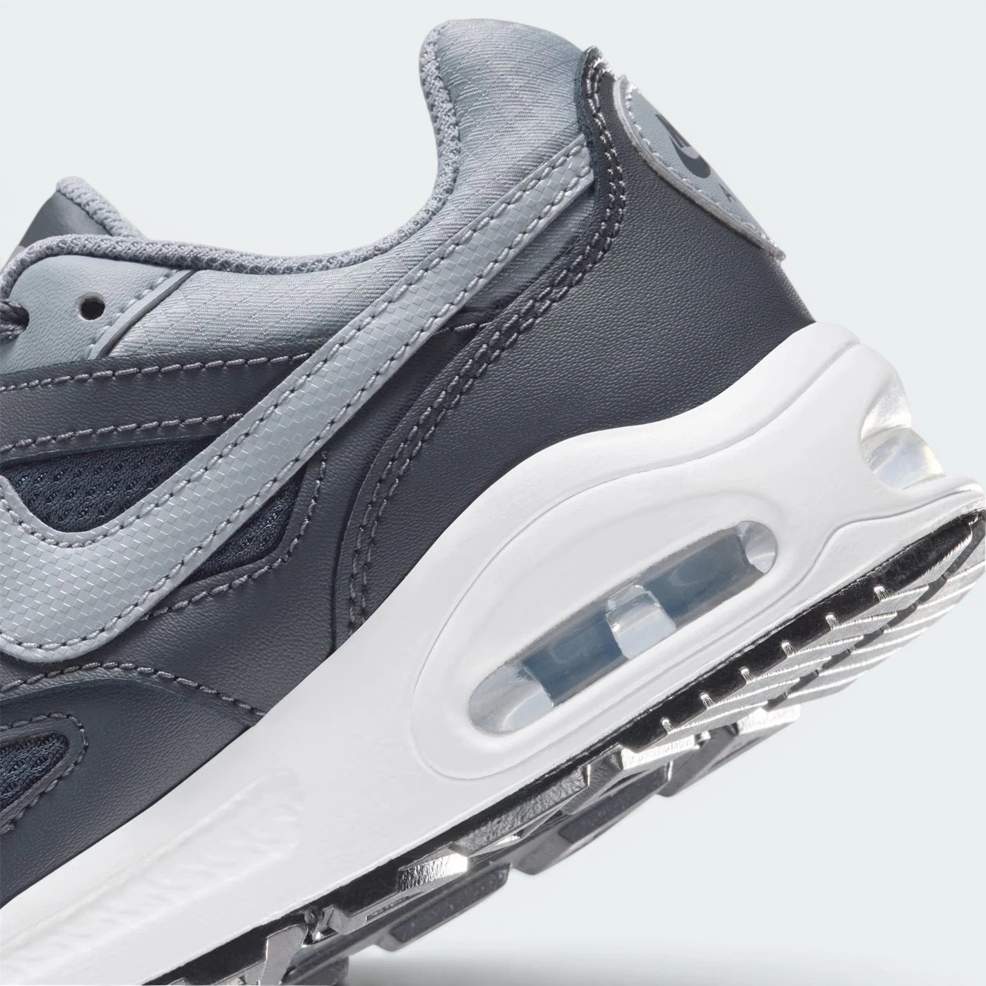 Highlights the "unreal" clean finish where the visible Max Air heel window cuts through the stable foam midsole wall.