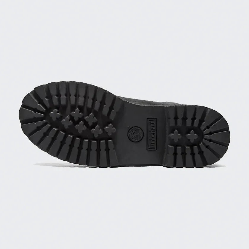 View of the outsole of the Timberland 6 Inch Premium Juniors' black boots, showing the rugged rubber lug pattern for superior traction.