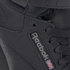 Close-up of Reebok Freestyle Hi 2240 black leather upper texture and stitching