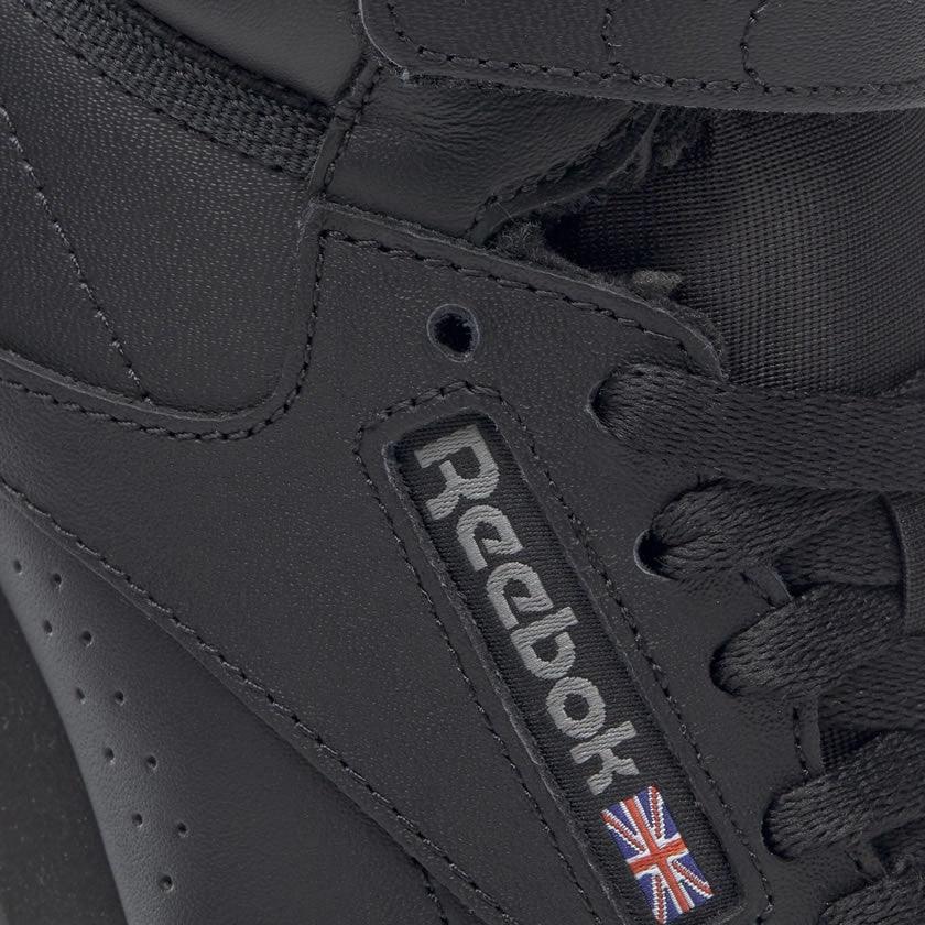 Close-up of Reebok Freestyle Hi 2240 black leather upper texture and stitching