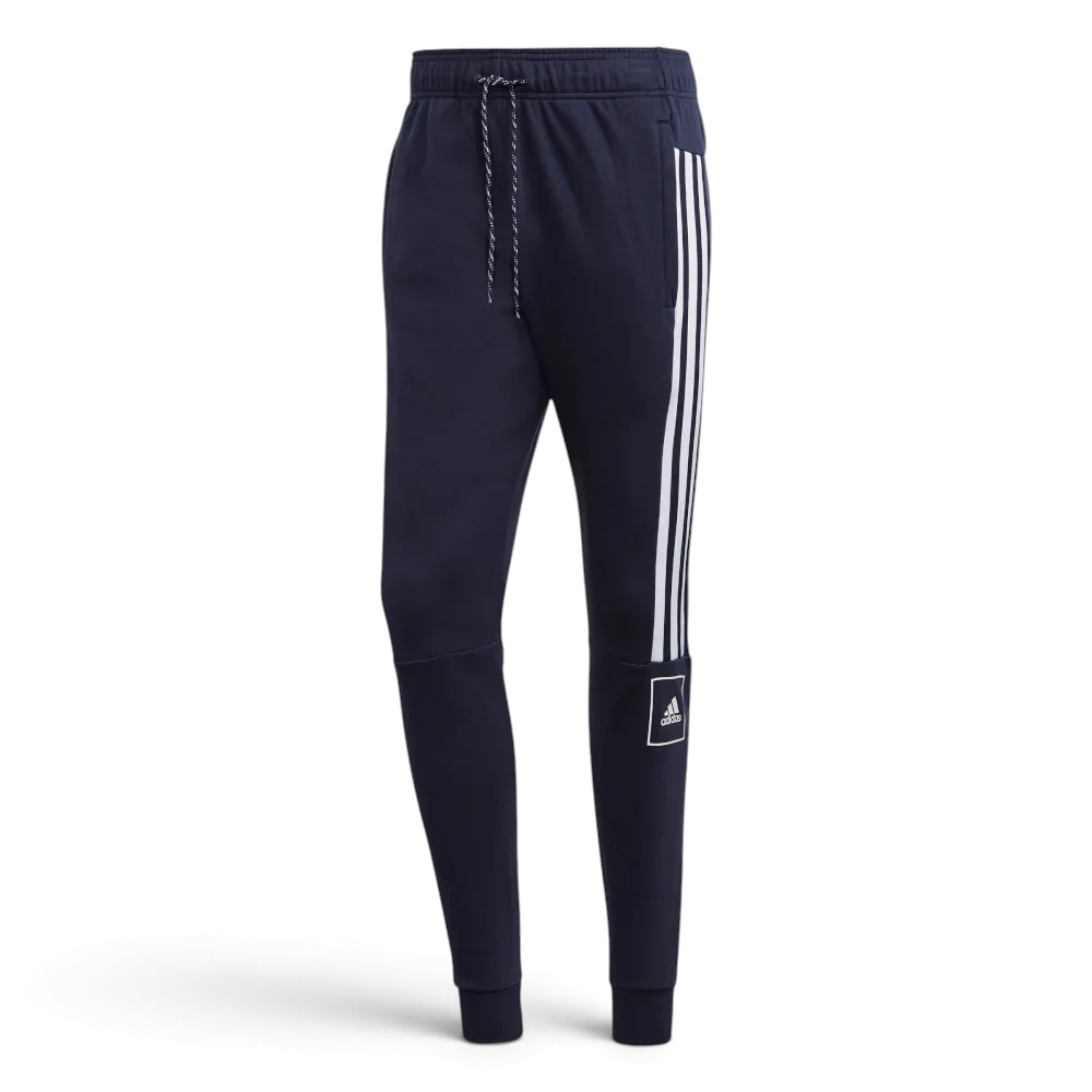 Navy blue Adidas jogger pants with white stripes on a light gray background