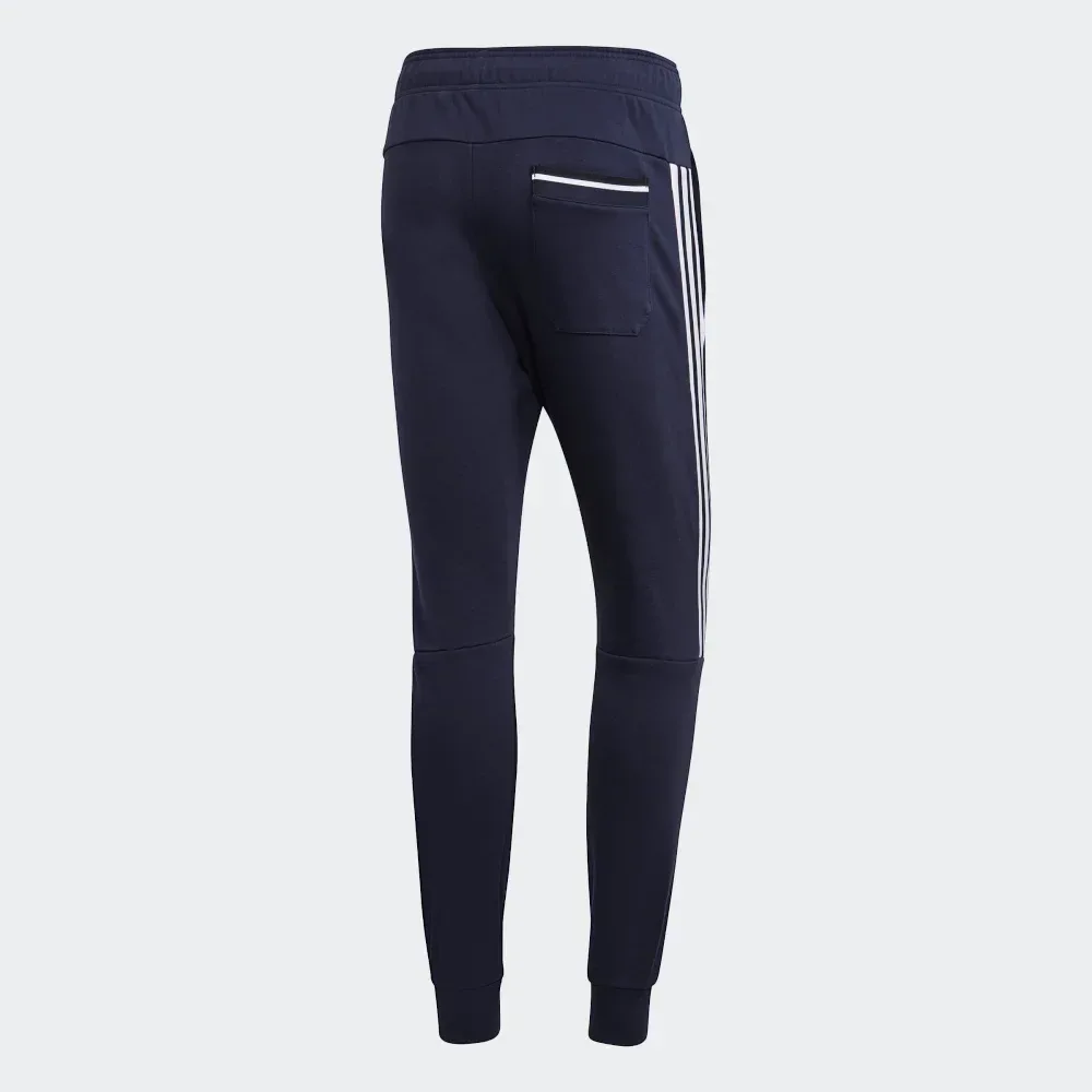 Navy blue jogger pants with white stripes on a light gray background