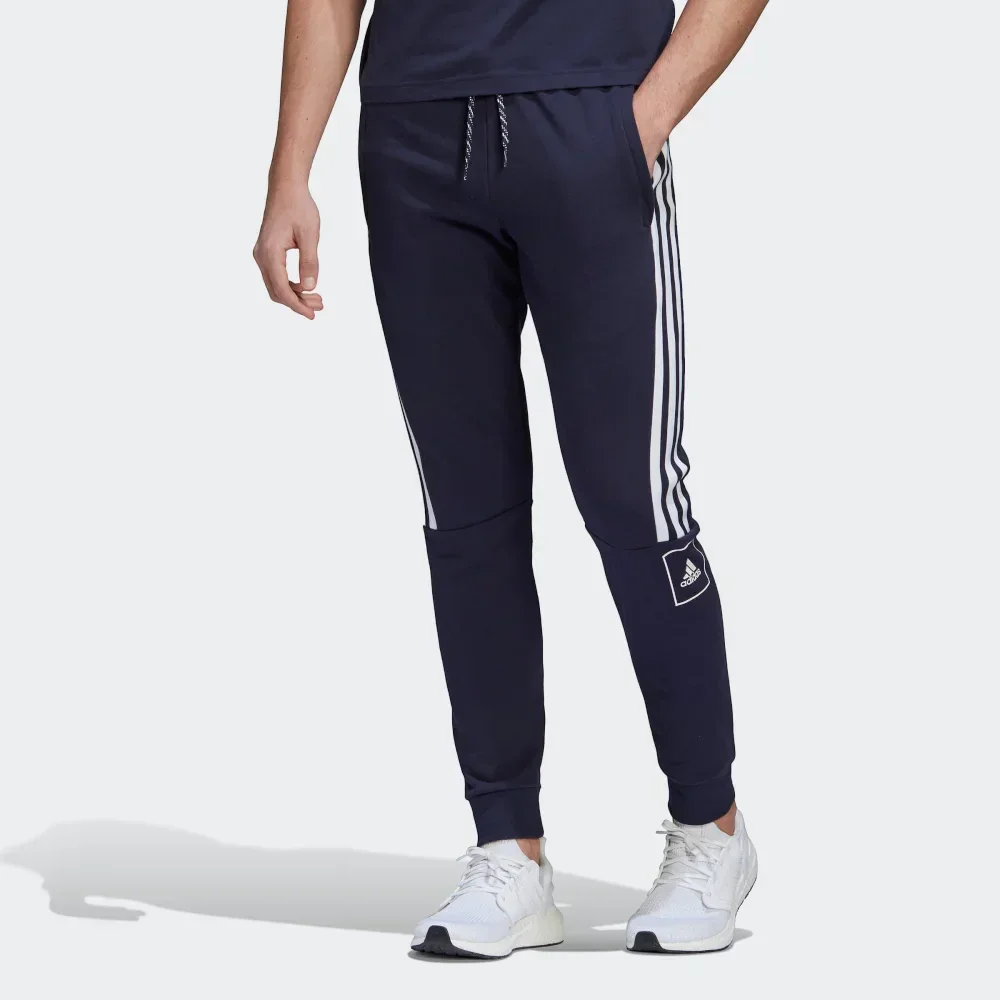 Navy tracksuit with white stripes and Adidas logo on a white background