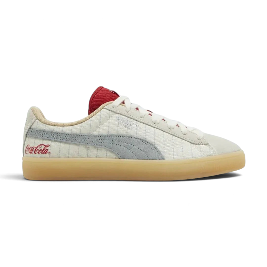 Puma Suede x Coca-Cola Unisex trainers in white suede with a red Formstrip, side profile showing the classic silhouette and a Coca-Cola branded heel tab. Main image
