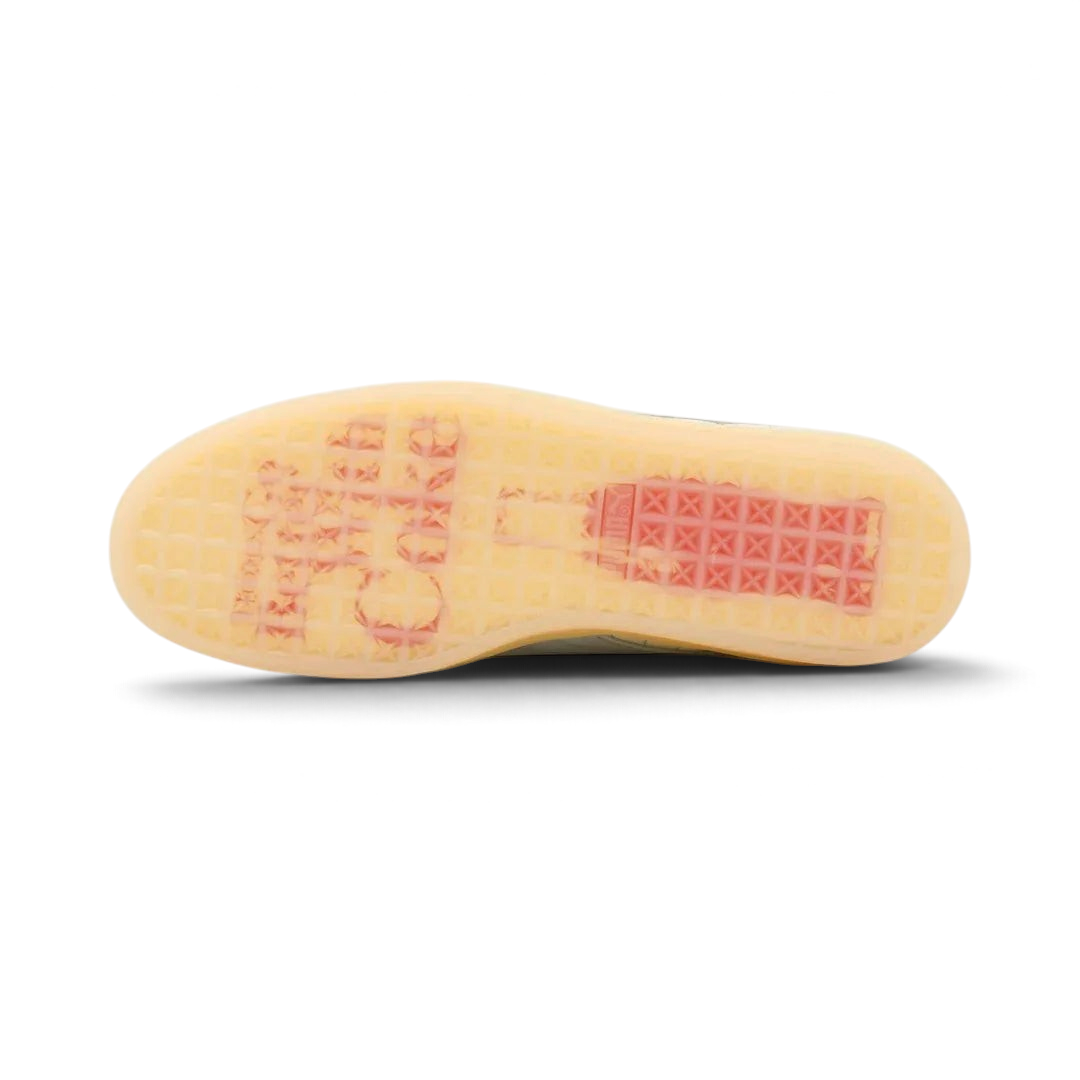 View of the outsole of the Puma Suede x Coca-Cola Unisex white trainers, showing the durable rubber cupsole and tread pattern.