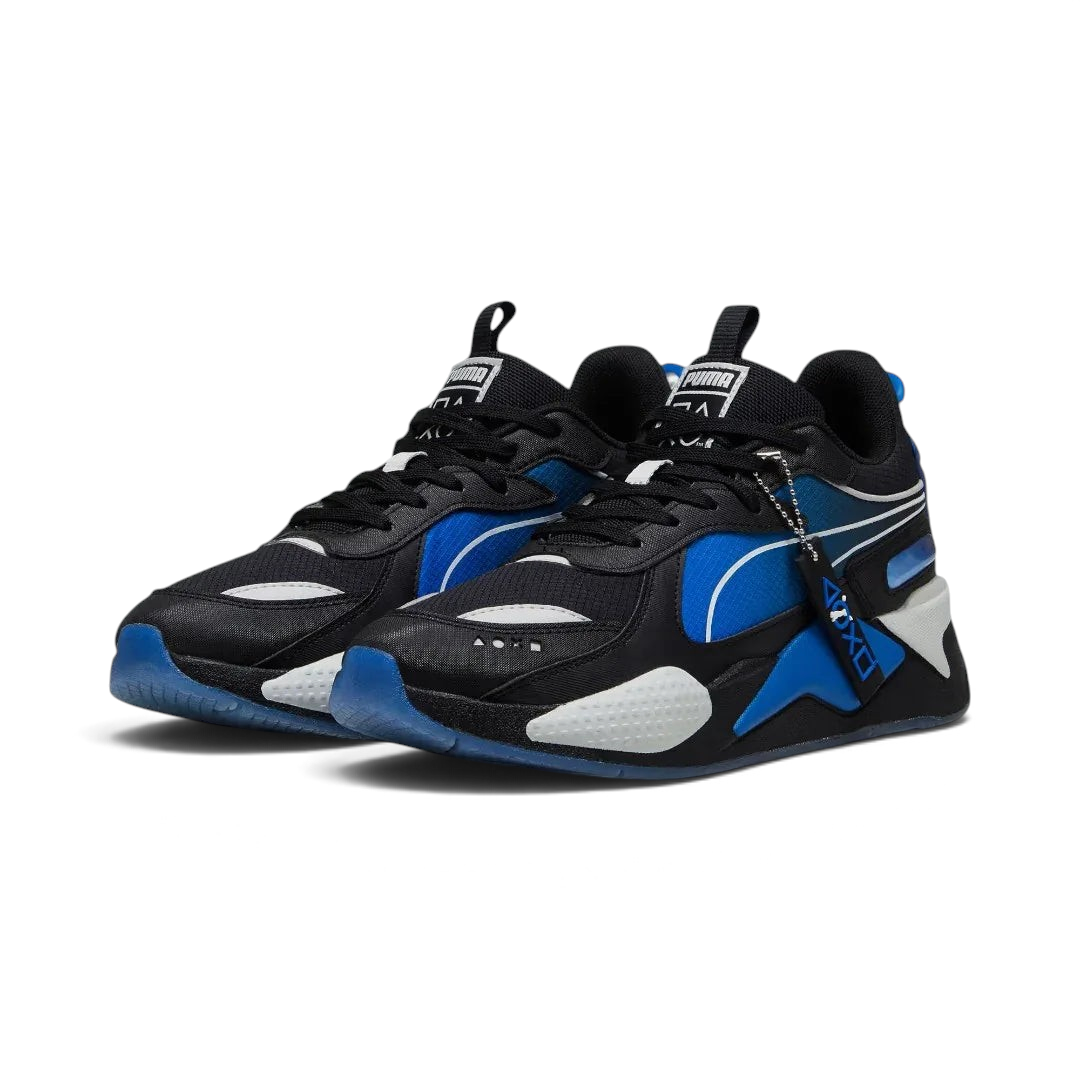 Angled view of two Puma RS-X x PlayStation Unisex trainers in black, side by side, showcasing their chunky silhouette and multi-colored gaming accents.