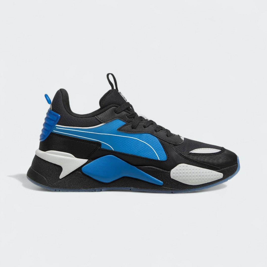 Puma RS-X x PlayStation Unisex trainers in black, inside profile showing layered upper, thick sole with RS cushioning, and PlayStation logo.